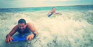 Dad and son swimming in the ocean