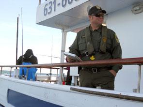 environmental police officer on deck of boat
