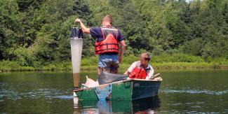 RIDEM staff collect zooplankton in the water column with a net