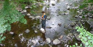 RIDEM staff test water at a stream monitoring location
