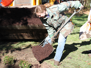 Women putting down mulch
