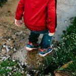 Child jumping in a puddle