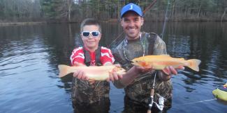Anglers with golden rainbow trout stocked by DFW hatchery staff
