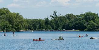 Kayakers paddling in Olney Pond at Lincoln Woods State Park