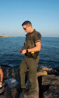 Environmental Police Officer checks fishing possession size and limits