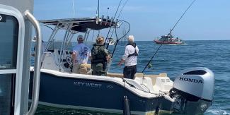 Environmental Police Officer on board a recreational fishing boat checking that fishing regulations are being adhered to