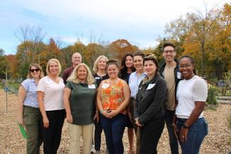 During the tour of the Mowry Commons farm property, attendees and students discussed how this community partnership can be sustained for lasting food system change.