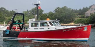 Red and white research vessel with the name of the boat: John H. Chafee