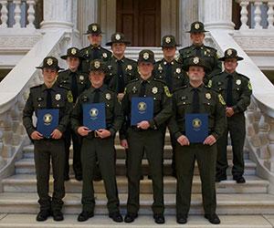 A group of environmental police officers in dress uniforms standing on the steps of the RI State House