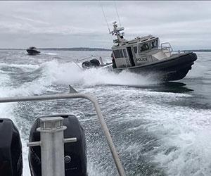 A environmental police boat maneuvering with speed through the water