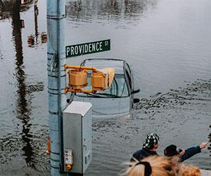 A street sign for Providence Avenue above the flooded street during RI's Great Flood in 2010