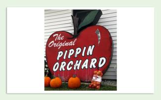 Apple shaped sign that says, "The Original Pippen's Orchard"